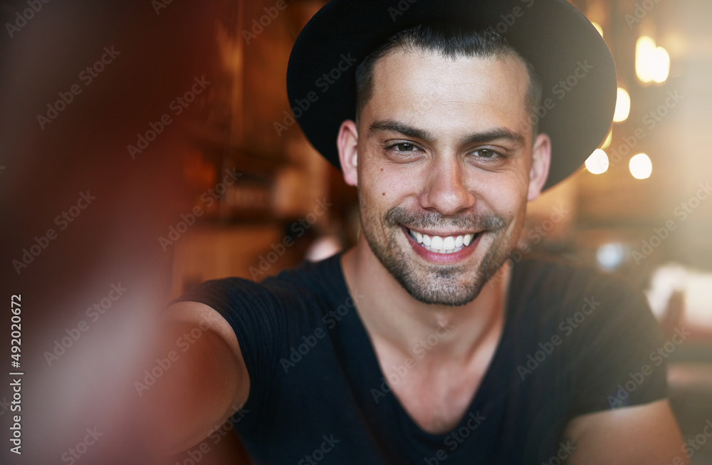 Smile if youre a satisfied customer. Portrait of a handsome young man taking a selfie in a coffee sh