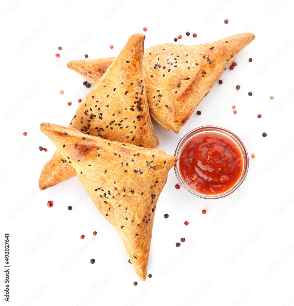 Tasty Uzbek samsa with tomato sauce on white background