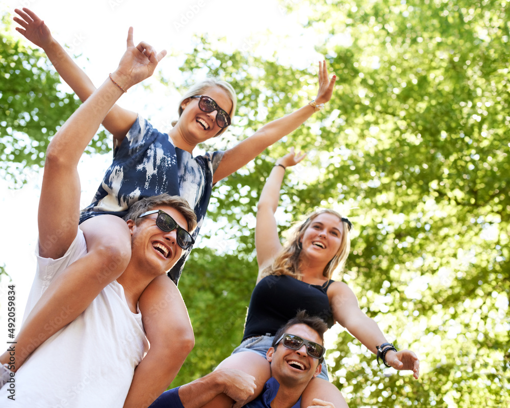 Partying. Two guys carrying their girlfriends on their shoulders at a music festival.