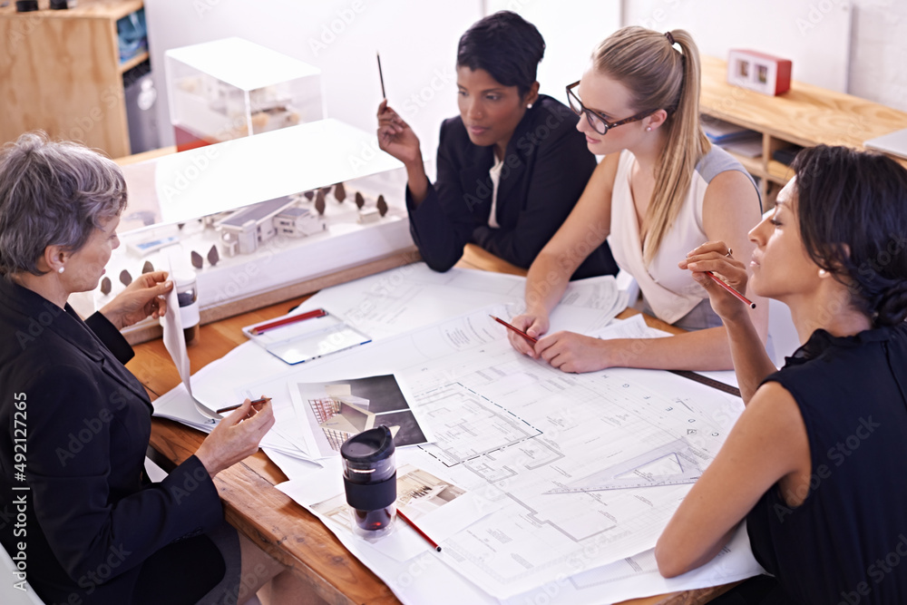 Meeting of the minds. A group of female architects working together on a project at a conference tab