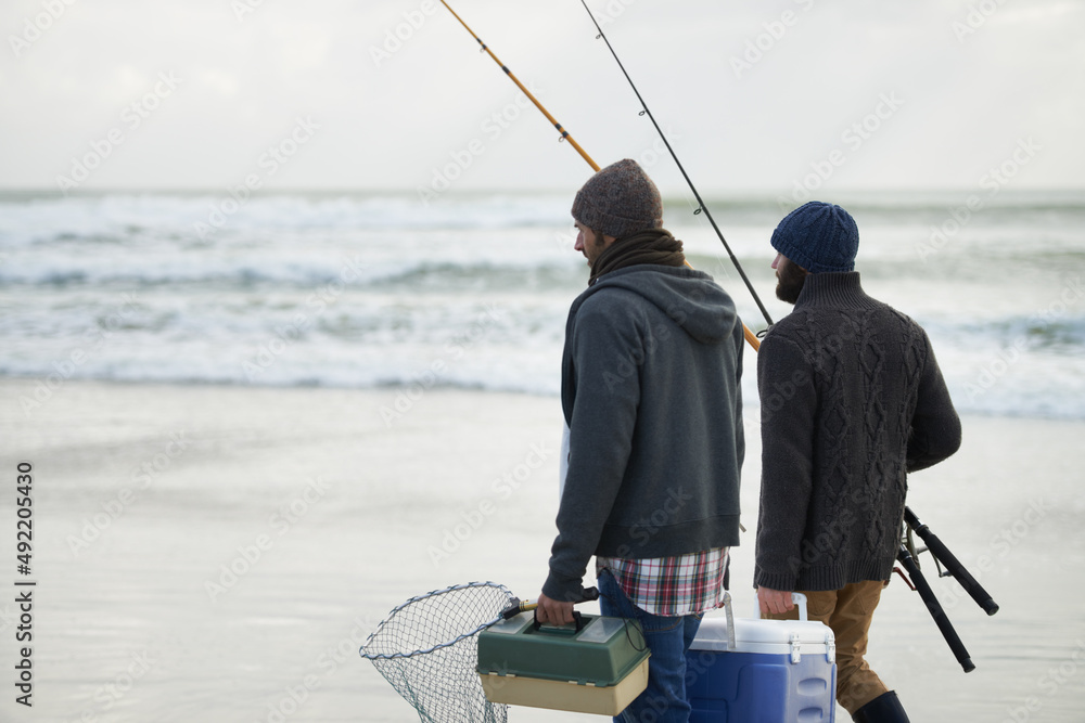 Packed and ready to fish. Shot of a two friends going fishing on an early overcast morning.