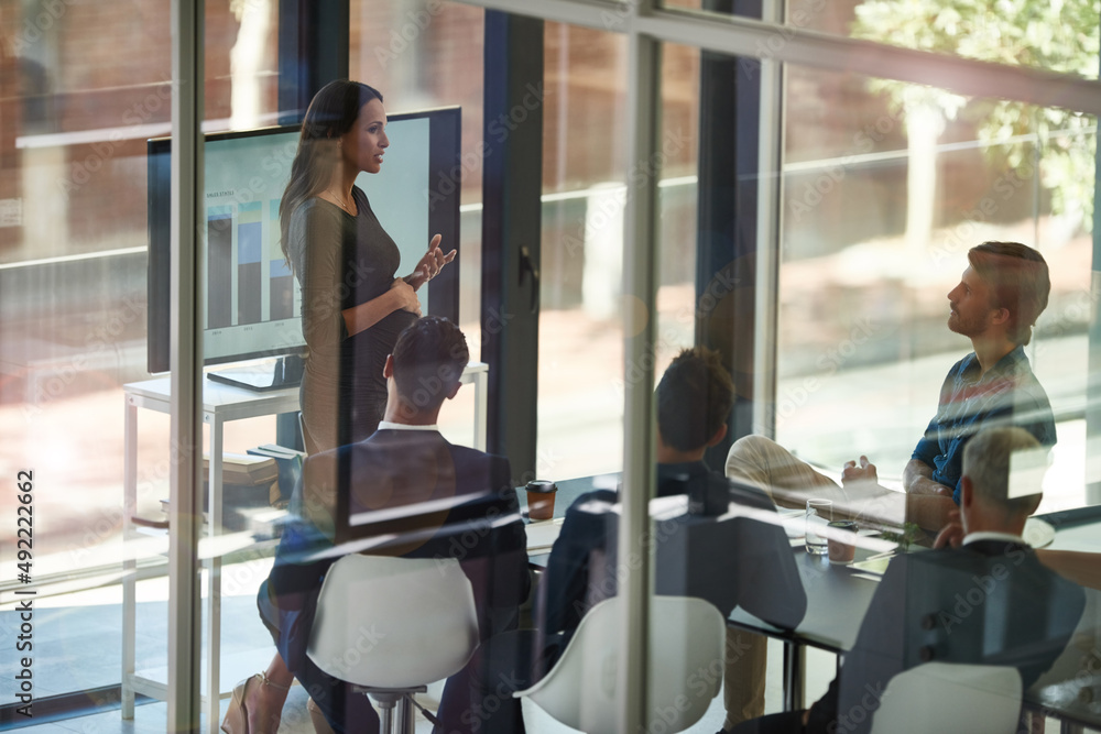 Taking stock and setting new targets. Shot of a corporate businessperson giving a presentation in th