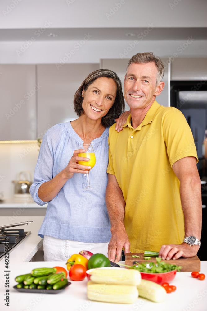 All you need is love... and good food. Portrait of a loving mature couple standing beside each other