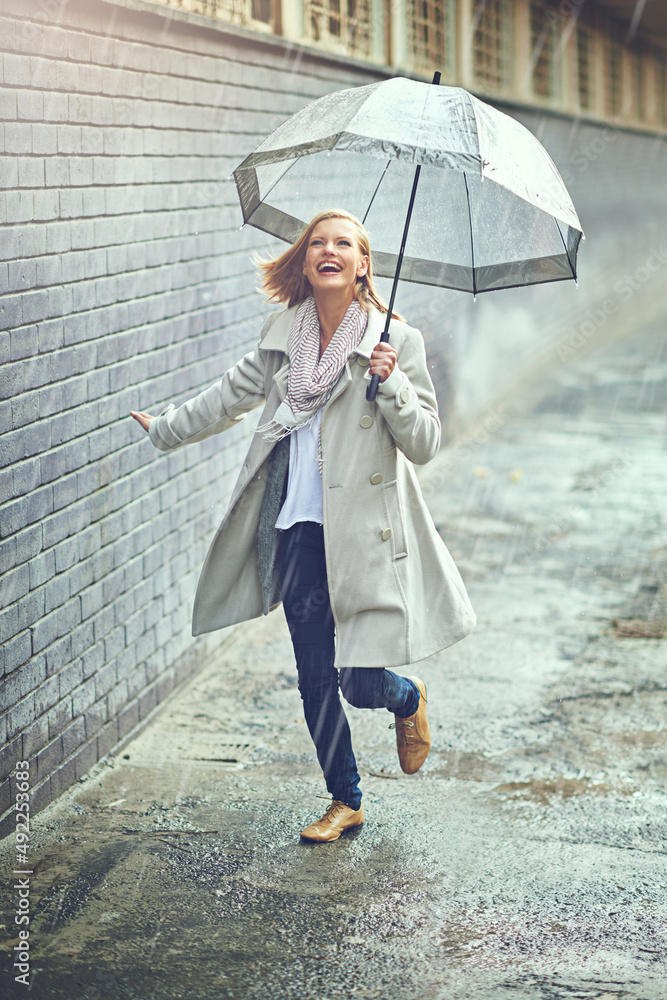 The rain never bothered her anyway. Full length shot of an attractive young woman playing in the rai