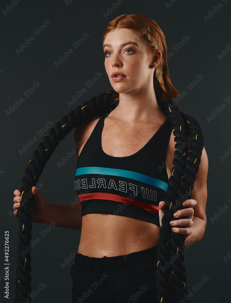 Making excuses is absolutely useless. Studio shot of a sporty young woman posing with a battle rope 