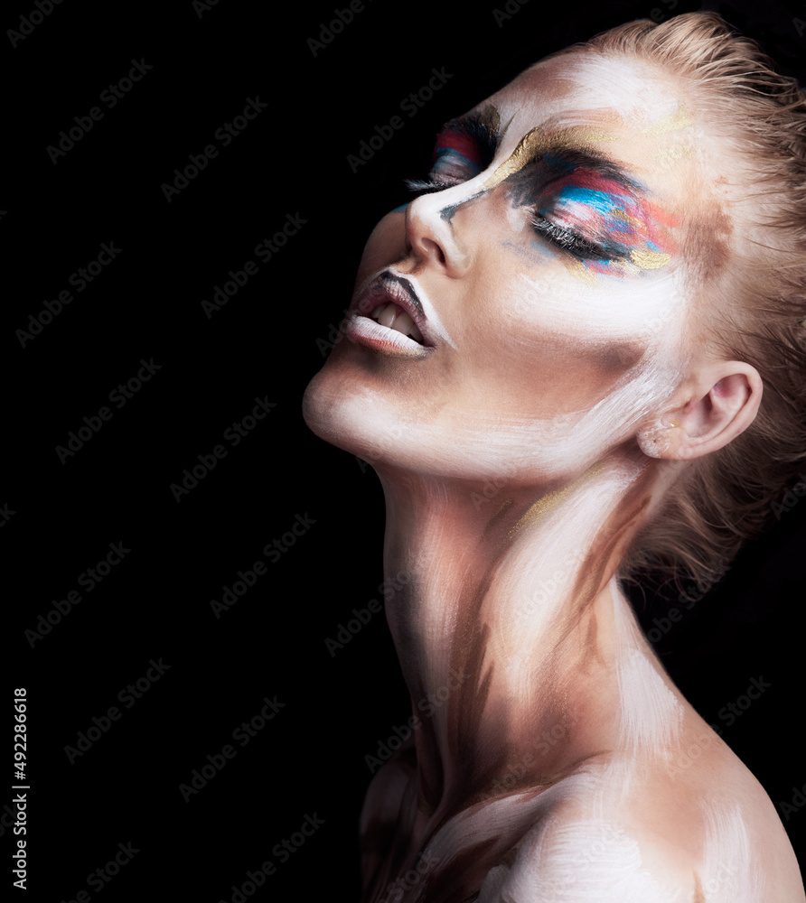 Her beauty is a work of art. Studio shot of a young woman posing with paint on her face isolated on 