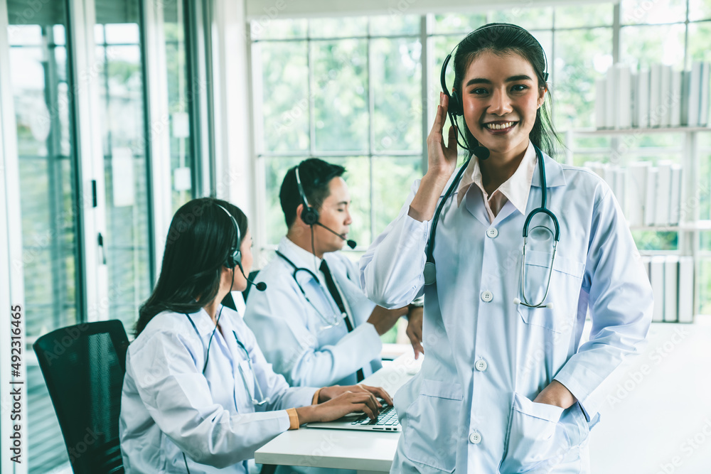 Doctor team wearing headset talking actively on video call in hospital clinic . Concept of telehealt