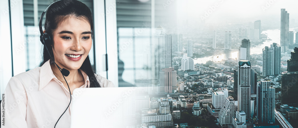 Businesswoman wearing headset working actively in office . Call center, telemarketing, customer supp