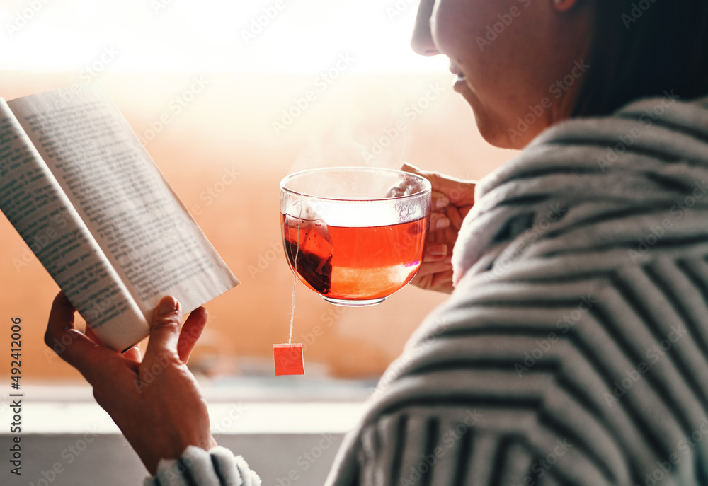 Reading books isnt a hobby, its a passion. Cropped shot of an unrecognizable young woman reading a b