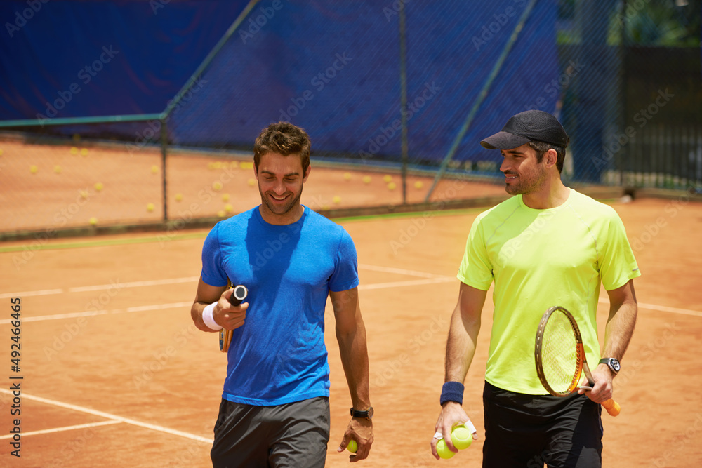 Their friends and great rivals on the court. Two male tennis players on the court.