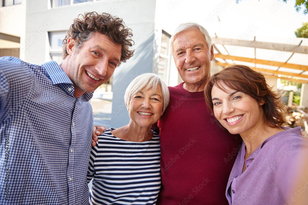 Smile everyone. Shot of a family taking a selfie outside.