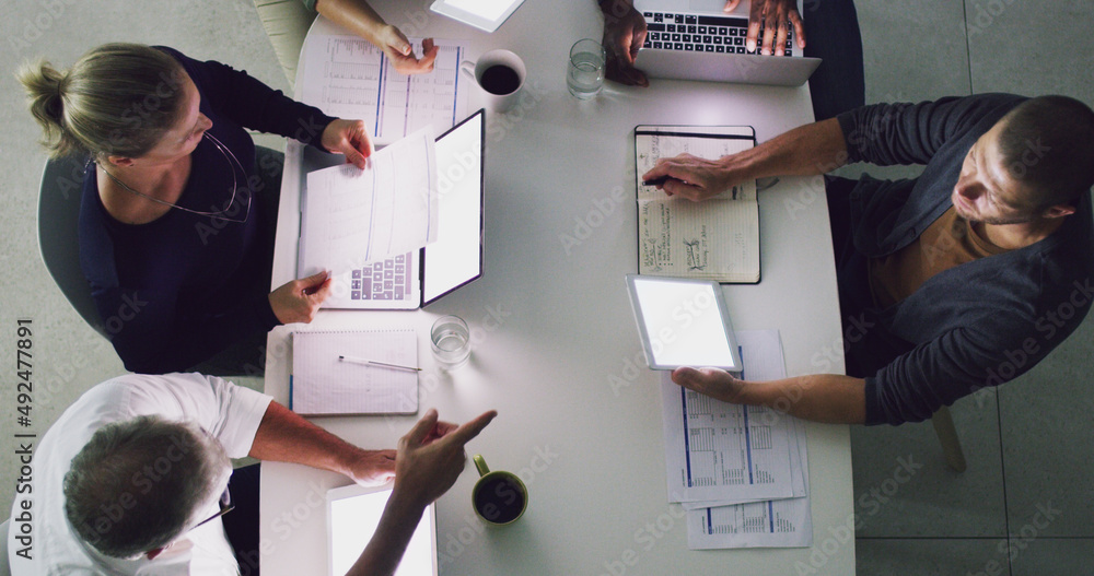 Success doesnt only happen from 9-5. High angle shot of a group of businesspeople working together a