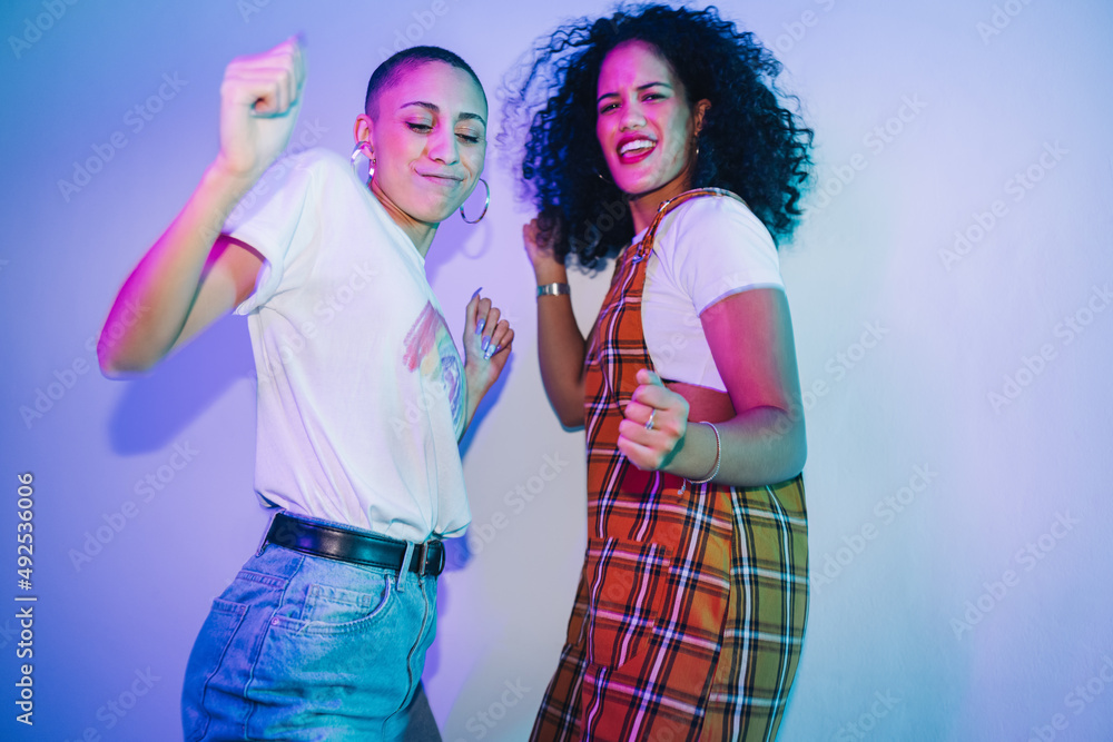 Female friends dancing together at a party