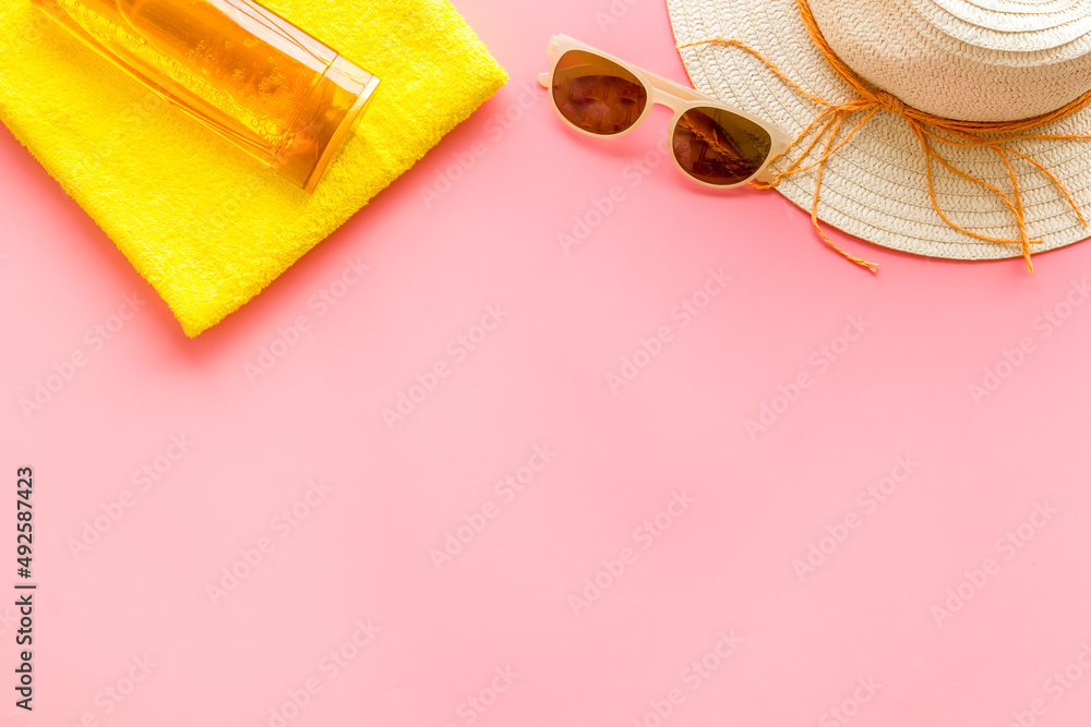 Summer beach vacation concept with straw hat and bottles od sunscreen