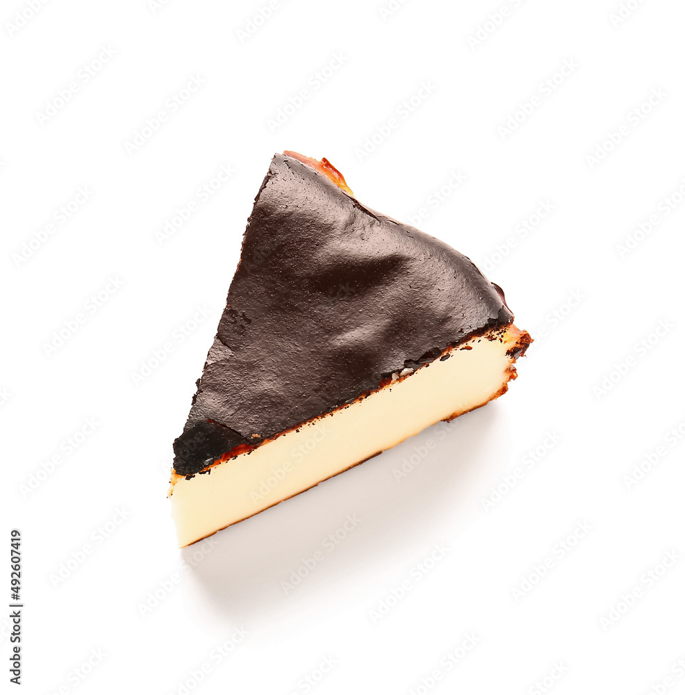 Slice of tasty Basque burnt cheesecake on white background