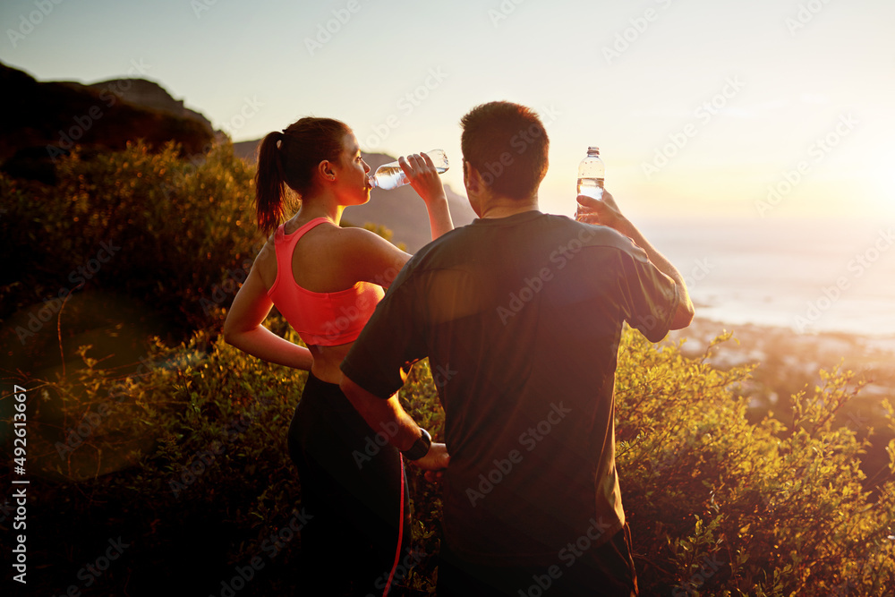 Keep yourself hydrated during your workouts. Cropped shot of a sporty young couple taking a break wh