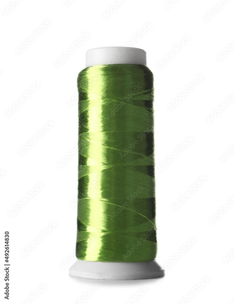 Green sewing thread spool on white background