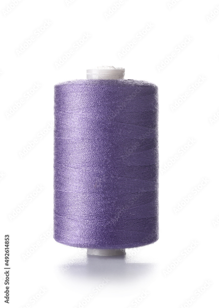 Purple sewing thread spool on white background