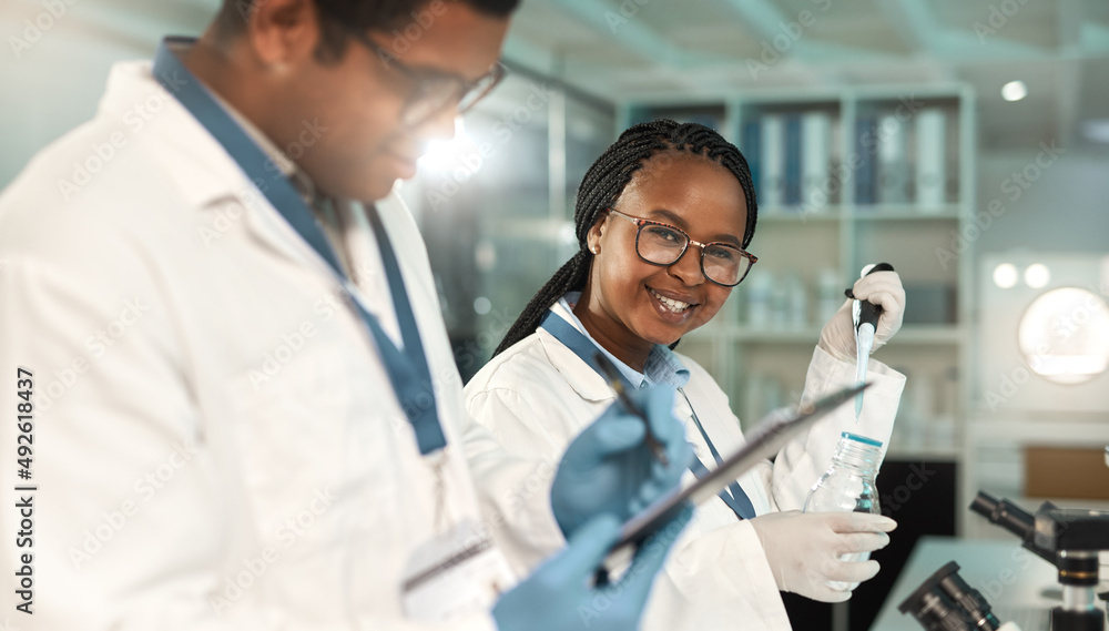 Uncovering something new. Portrait of a young scientist working alongside a colleague in a lab.