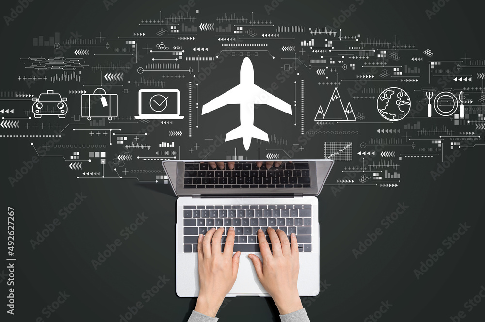 Flight ticket booking concept with person using a laptop computer