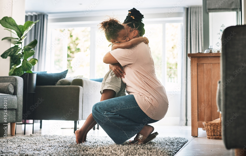 Hug it out. Shot of a mother and child hugging at home.