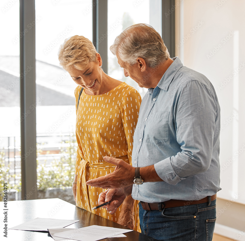 Ill go through them with you. Shot of a senior male realtor going through paperwork with a client.