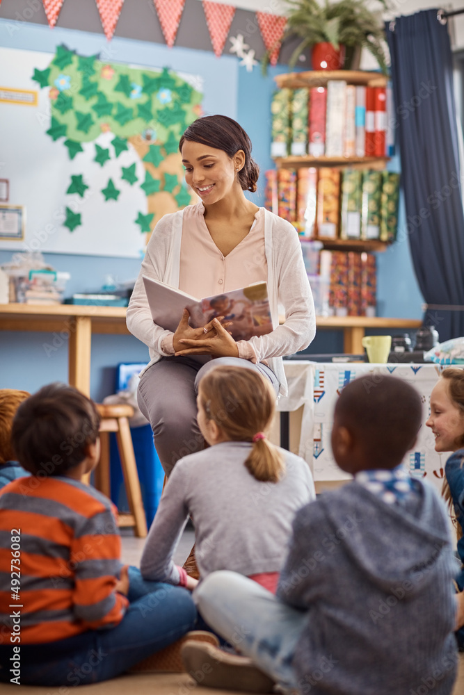 Reading opens up their imaginations even further. Shot of a teacher reading to a group of elementary