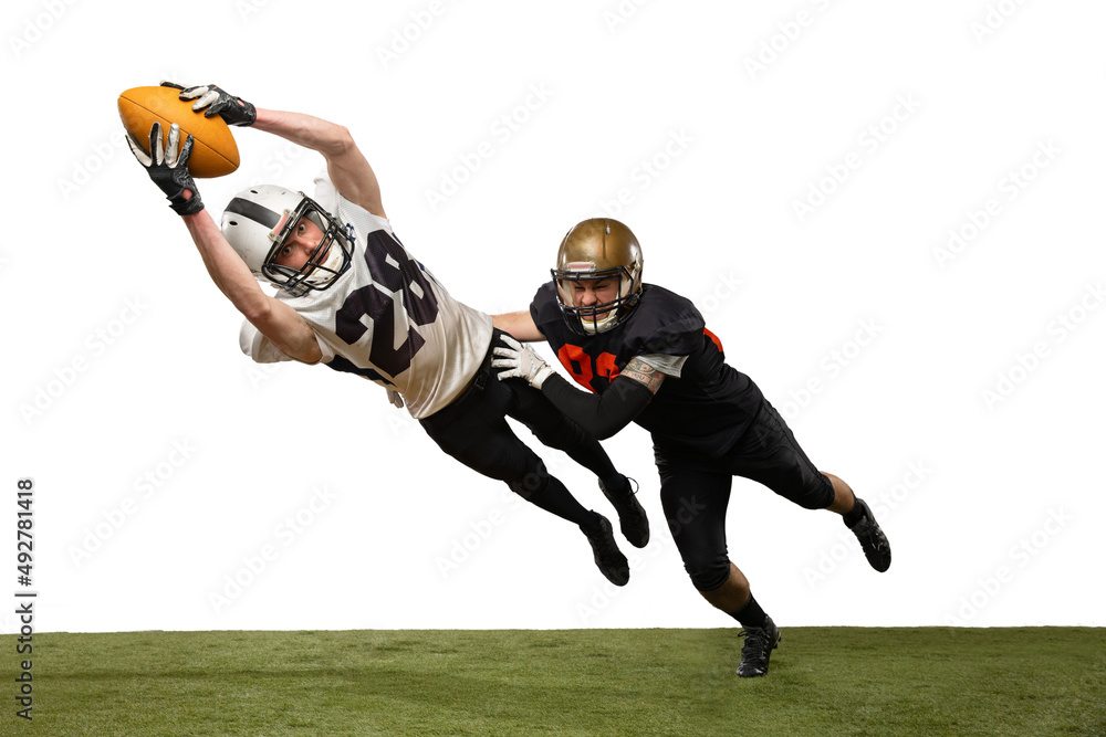 Two male american football players playing during sport match on grass flooring isolated on white ba