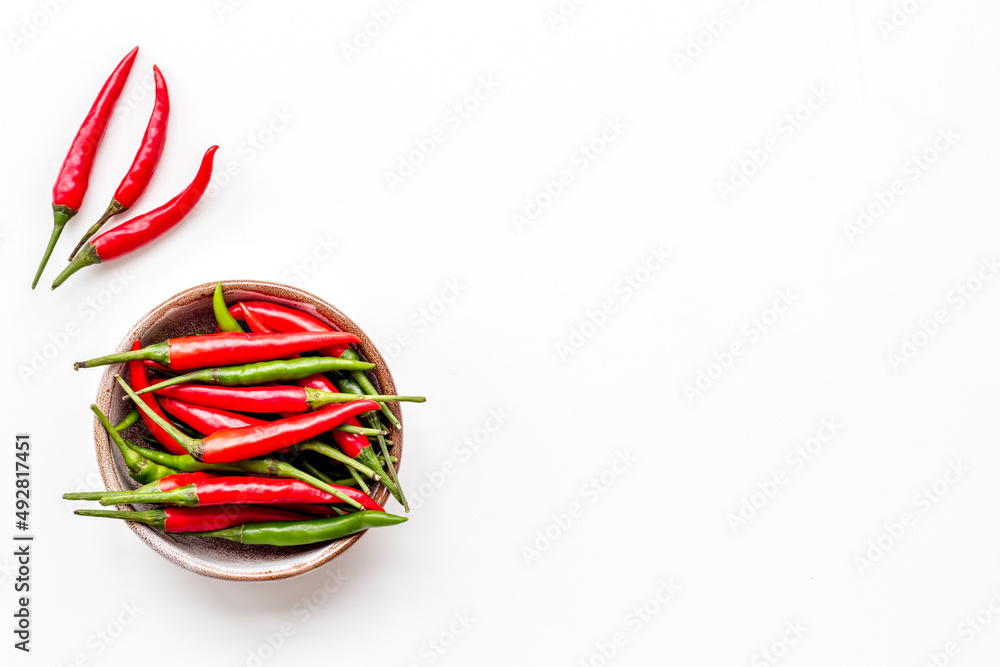 Cooking hot food with chilli pepper on white table background top view copy space