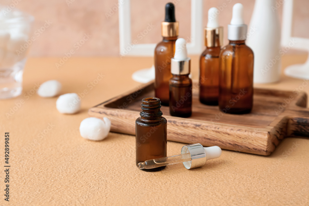 Bottle of natural essential oil on color background