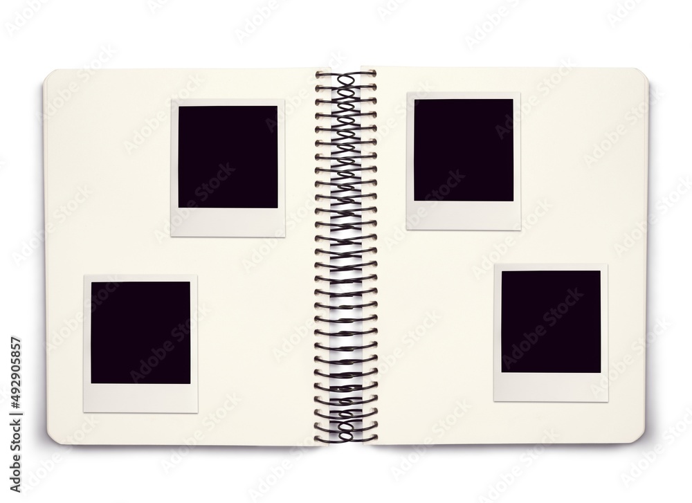 Photo album spread with empty photo frames on the notebook