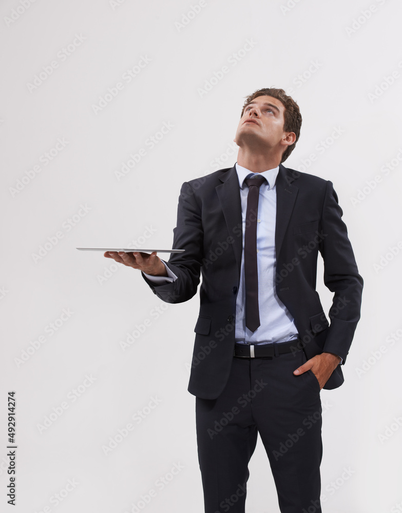 All my information is on the cloud. Shot of a handsome young businessman holding a digital tablet lo