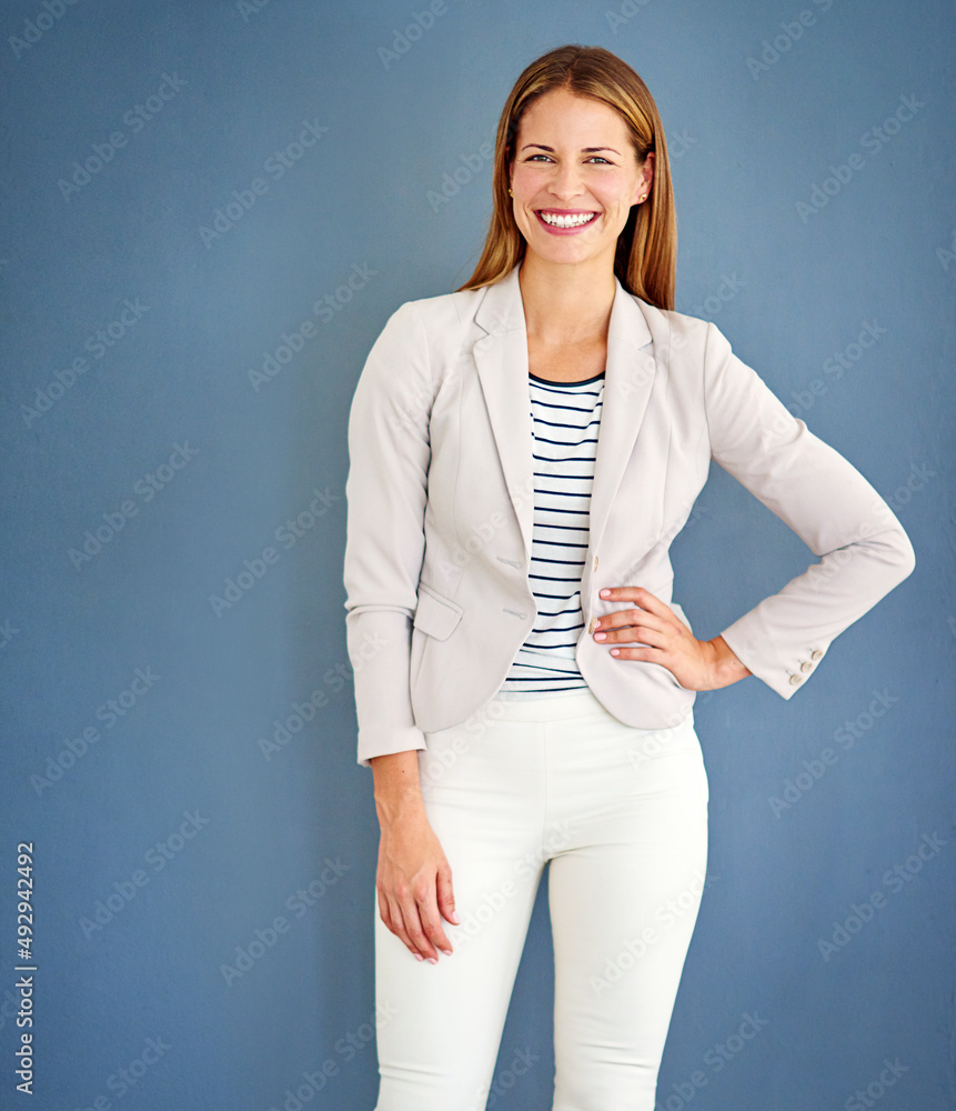 Dressed for success. Shot of a woman dressed in office-wear posing against a blue background.