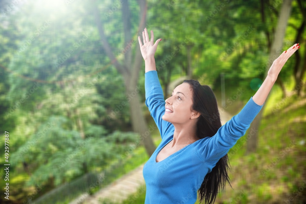 Overjoyed happy woman enjoying the green beautiful nature, healthy natural lifestyle