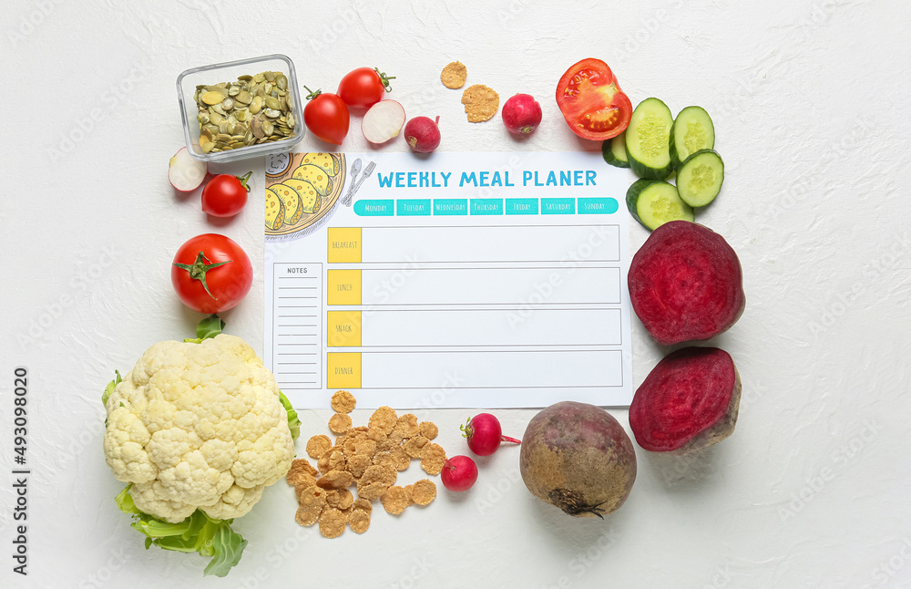 Weekly meal planner and different healthy products on light background