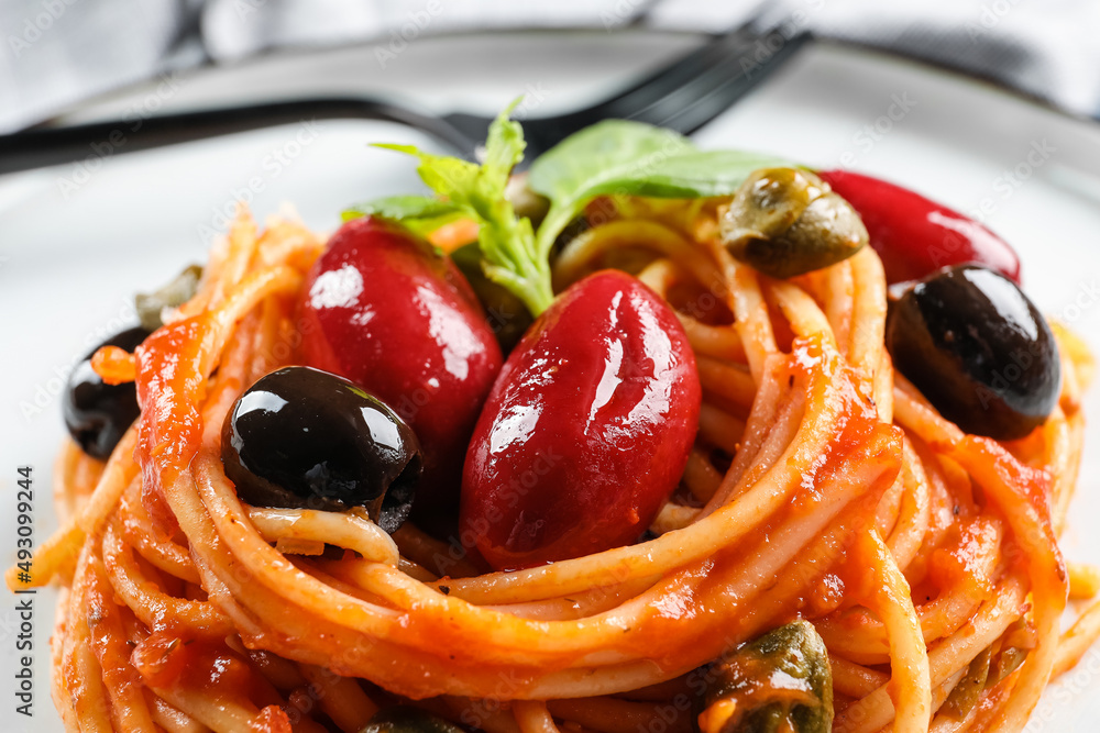 Plate with delicious Pasta Puttanesca, closeup