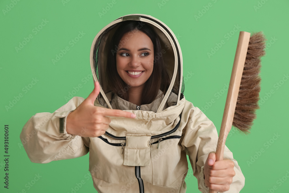 Female beekeeper on color background