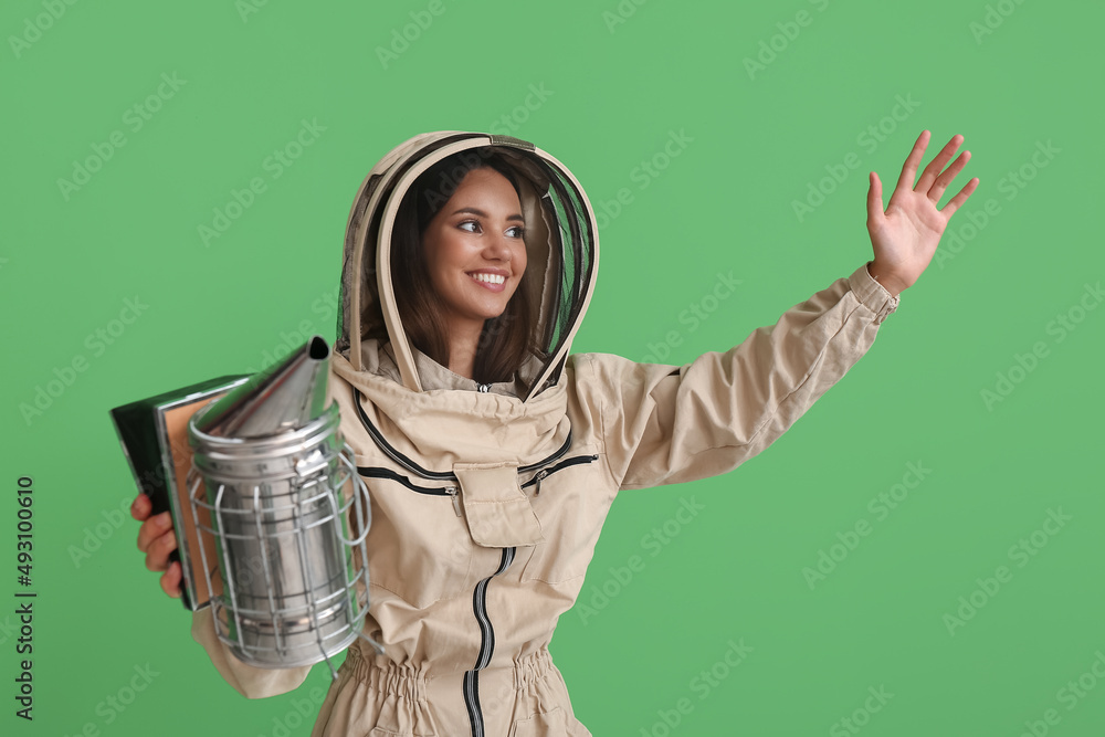 Female beekeeper on color background