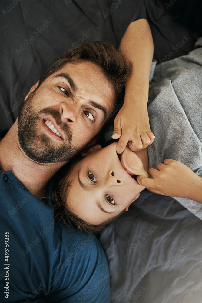 Having a silly day at home. Shot of a young boy and his father spending some quality time at home.