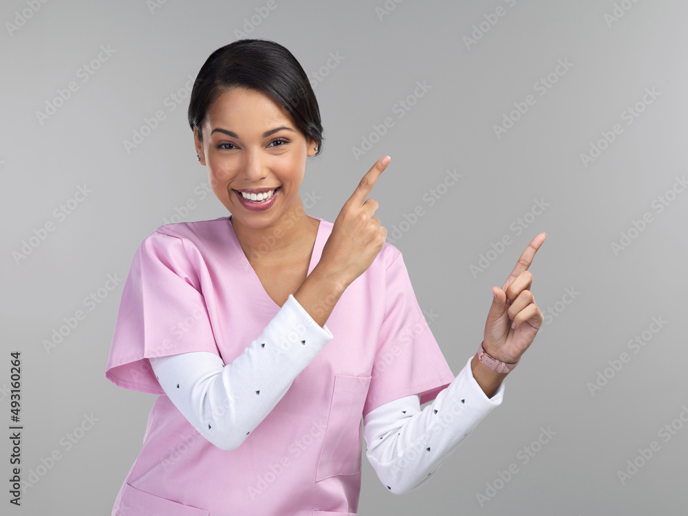 Picture your product, here. Cropped portrait of an attractive young female healthcare worker pointin