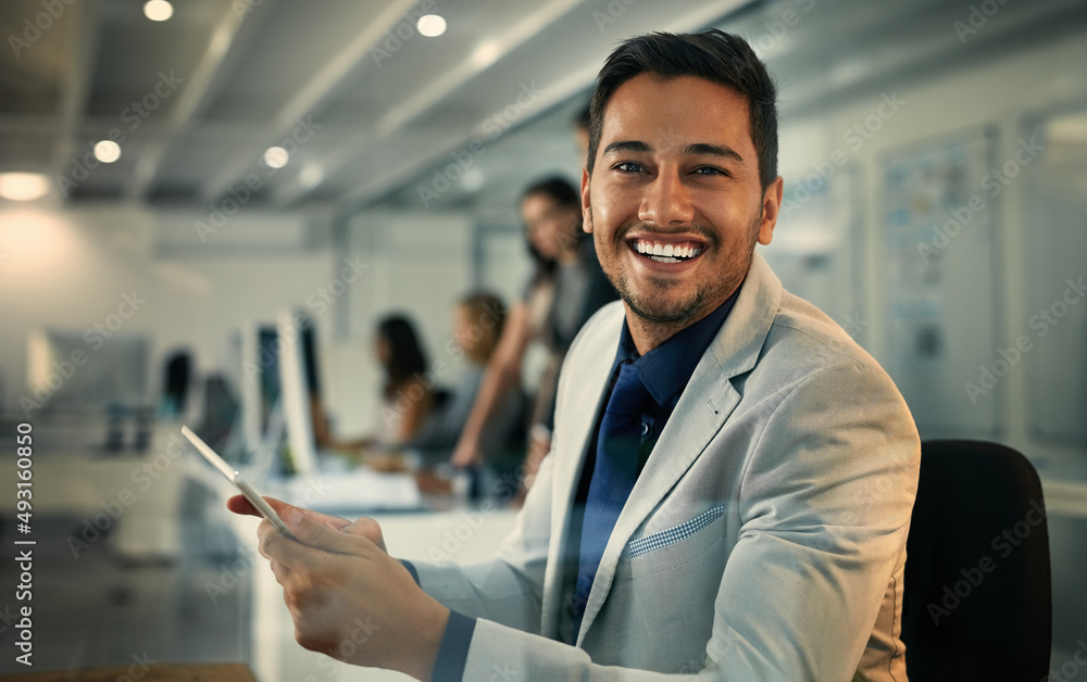 No shortage of information thanks to modern technology. Portrait of a young businessman using a digi