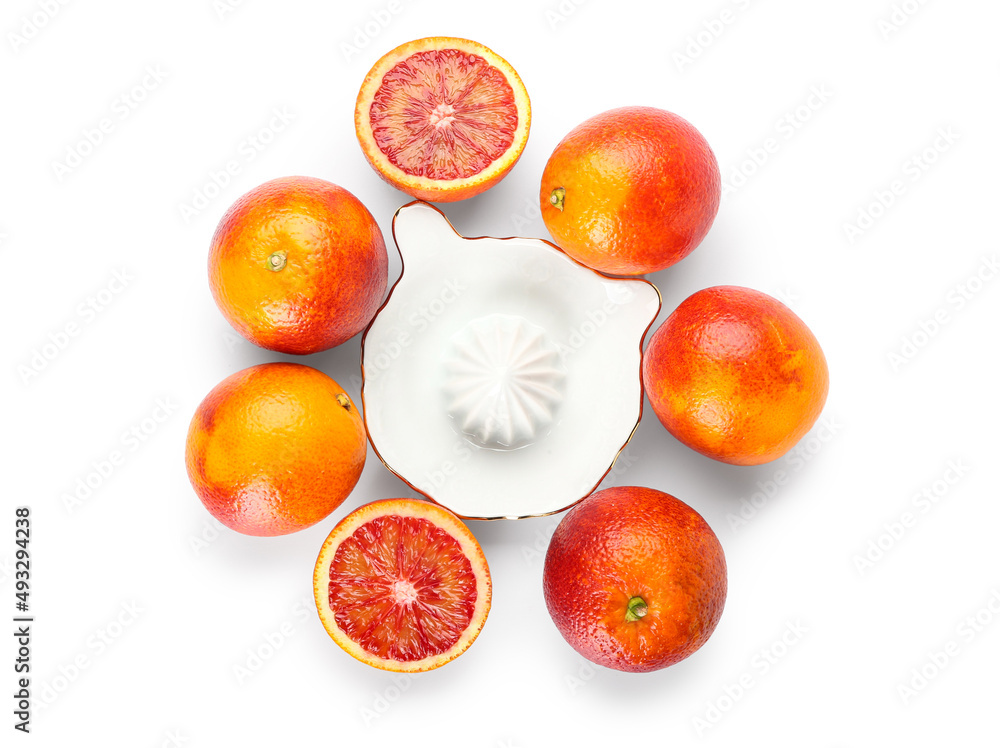 Ceramic juicer and grapefruits on white background