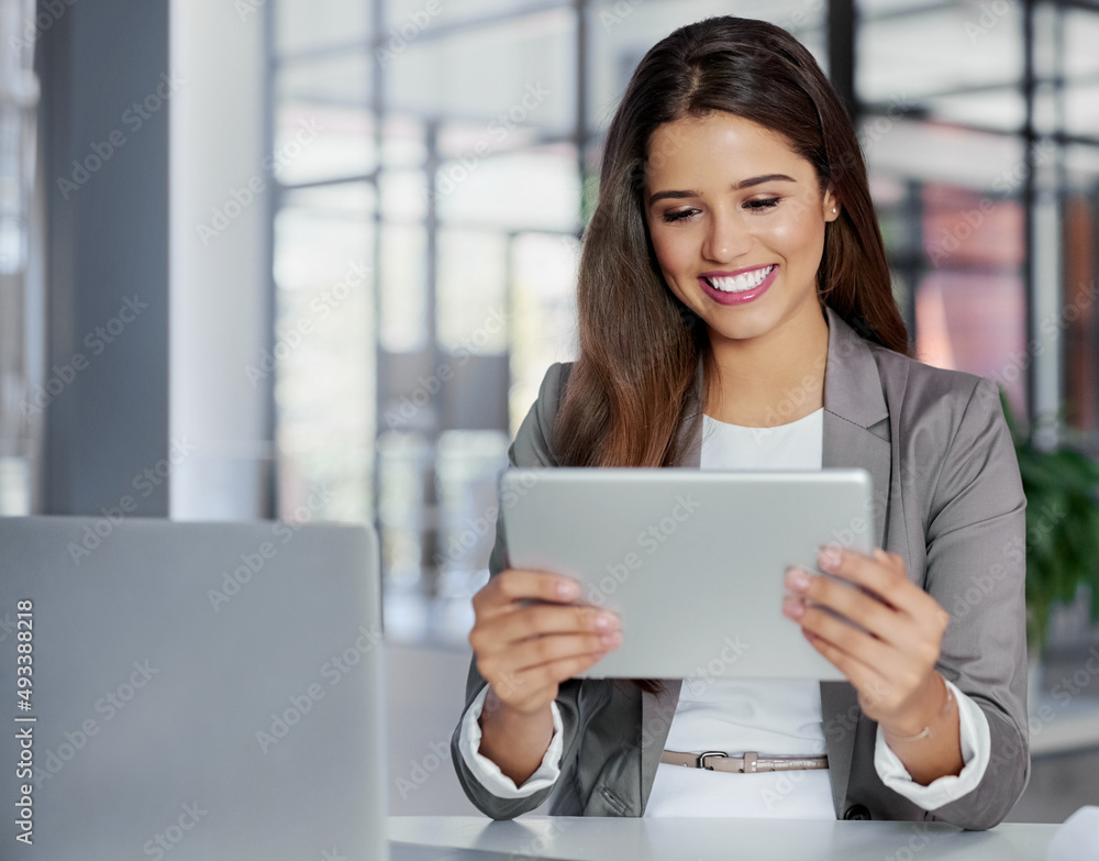 Every expert needs the right tools. Shot of a young businesswoman working on a digital tablet in an 