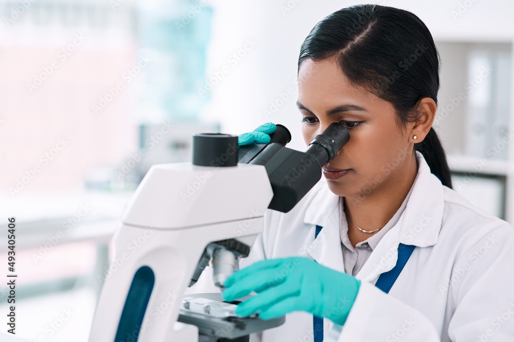 Shes one look away from making a discovery. Cropped shot of an attractive young female scientist loo