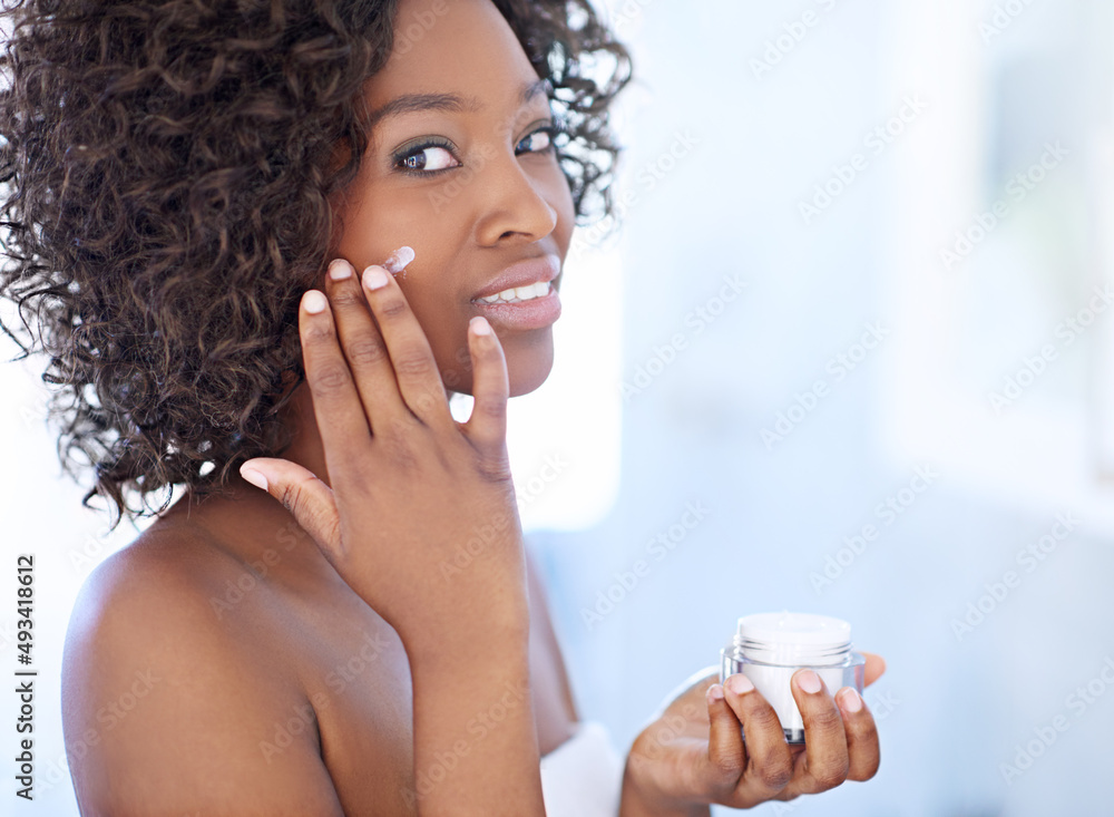 No to dark spots, yes to luminosity. Shot of a beautiful young woman during her daily beauty routine