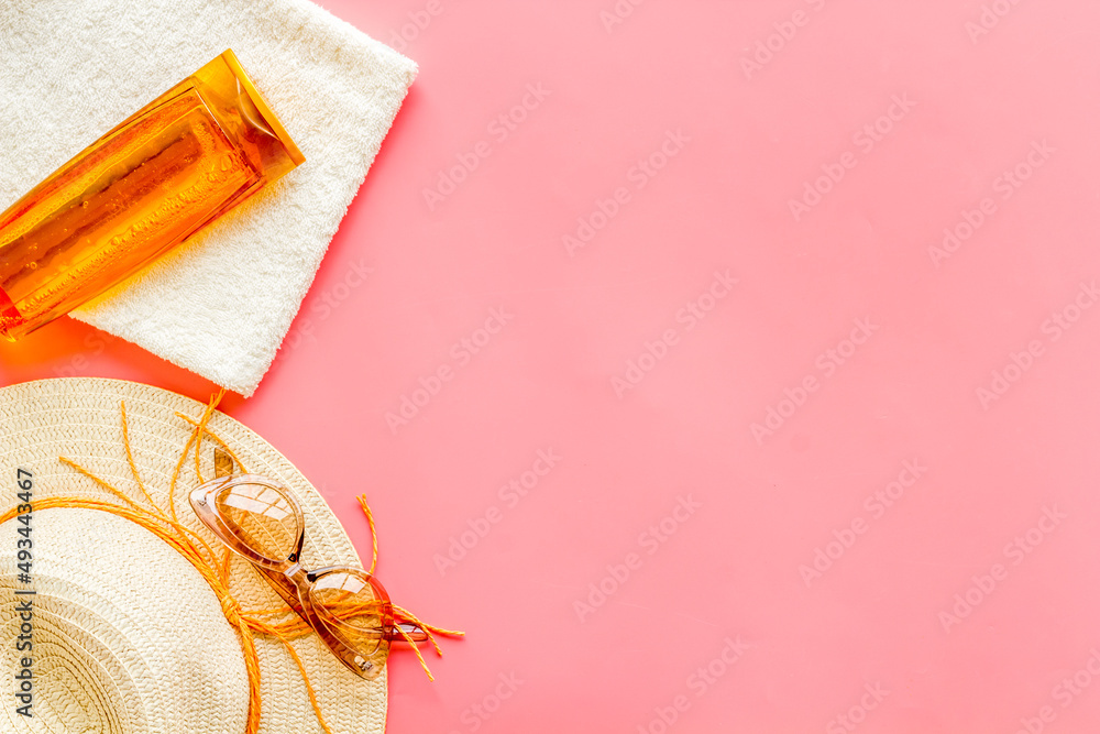 Summertime concept with straw hat and bottles od sunscreen