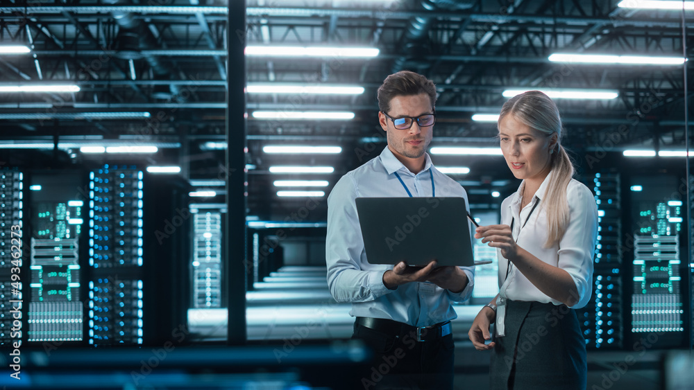 Male and Female Programmers Talking about Work, Solving Problems Together, Using Laptop Computer. So