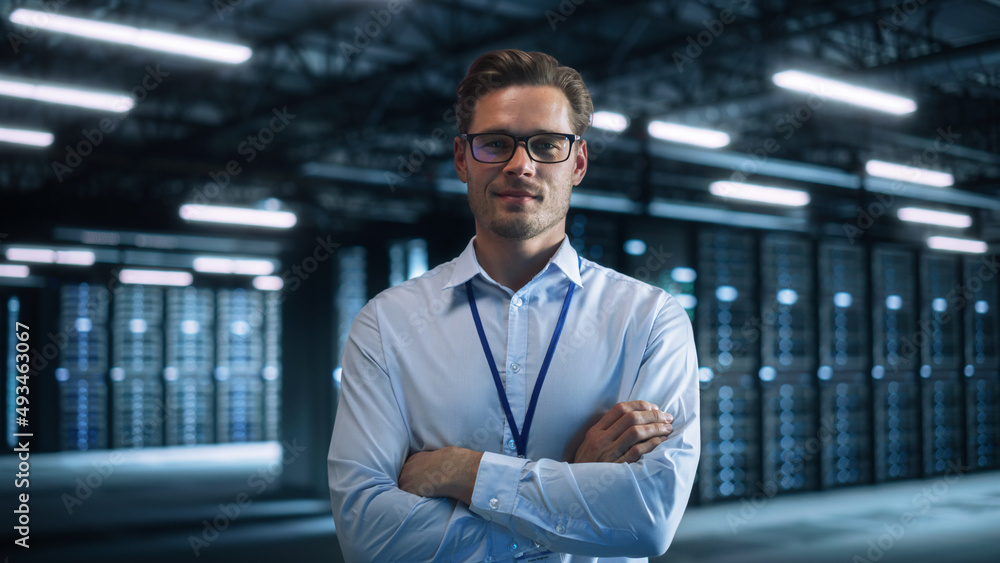 Male IT Engineer Working with Laptop in Data Center. Technician or Developer Standing at the Server 