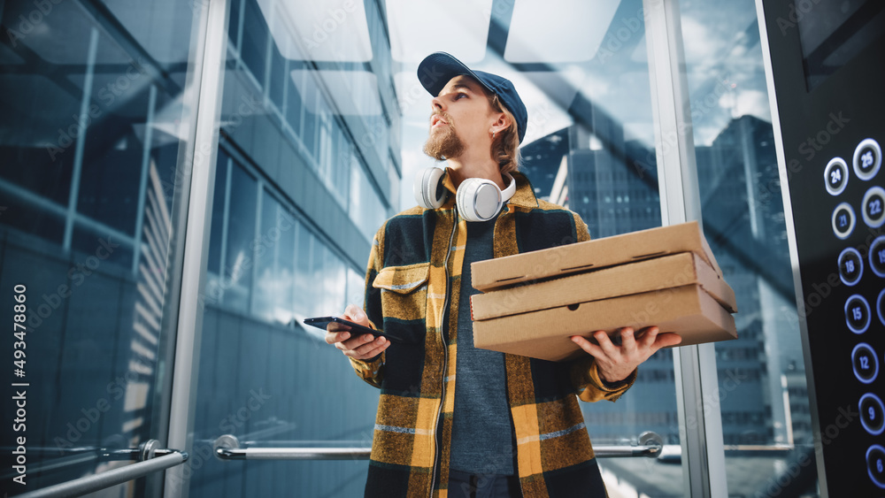 Young Food Delivery Person Riding Glass Elevator in Modern Office Building. Restaurant Courier Holdi