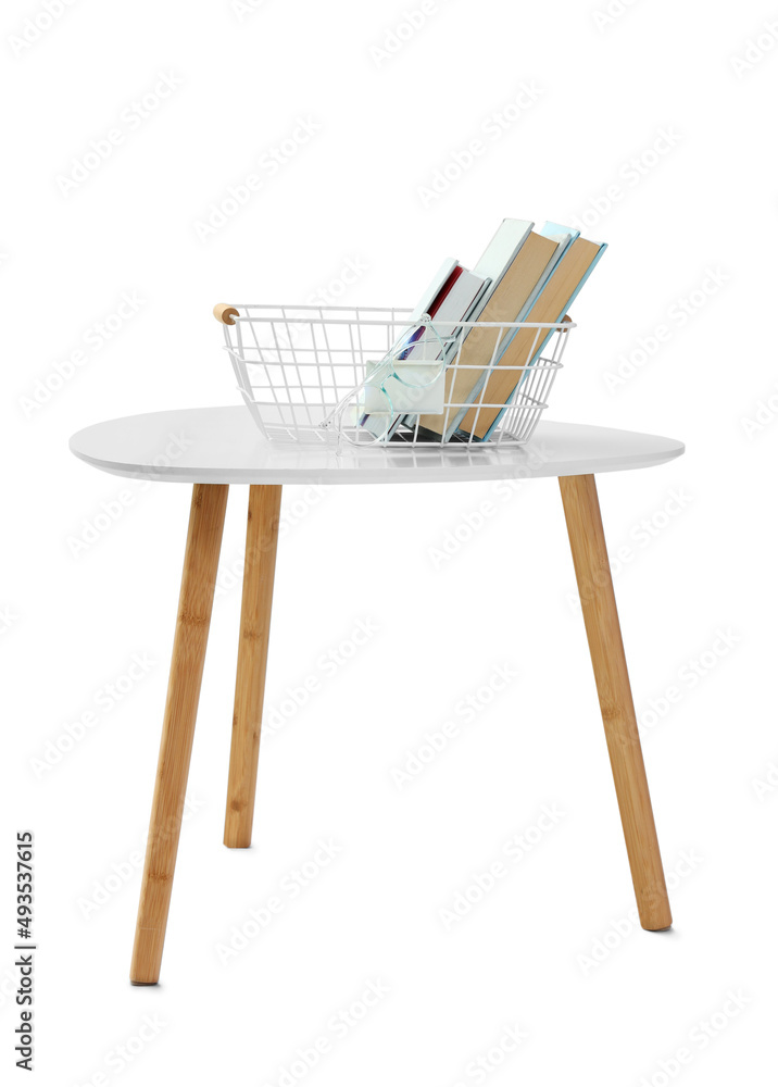 Modern bedside table with basket and books on white background